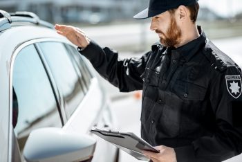 Policeman knocking at the car window