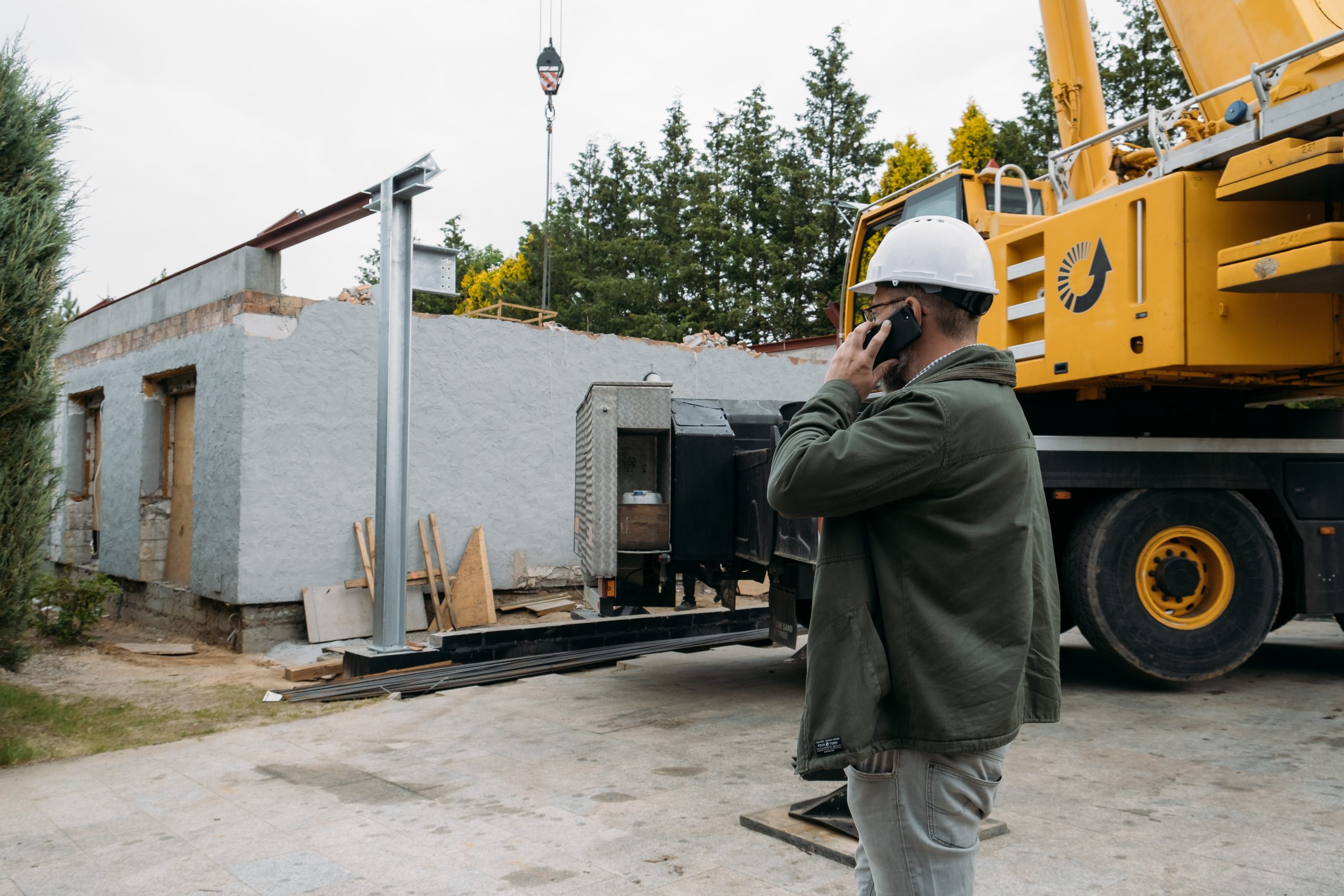 Foreman or architect on construction site talking by mobile phone