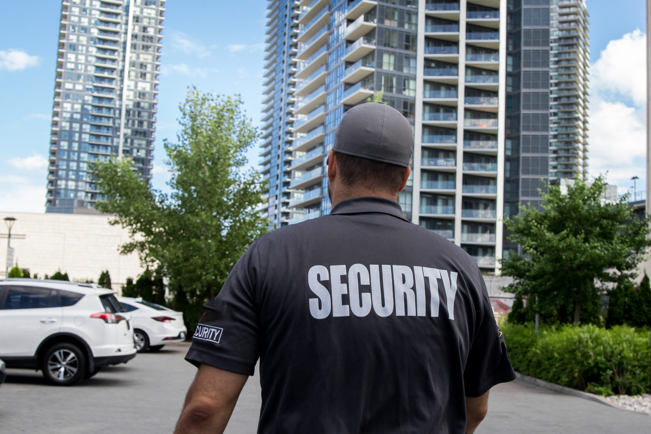 Security guard in uniform patrolling a residential area.