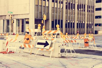 construction-barriers-block-street-in-urban-downto-2026-03-26-11-36-45-utc